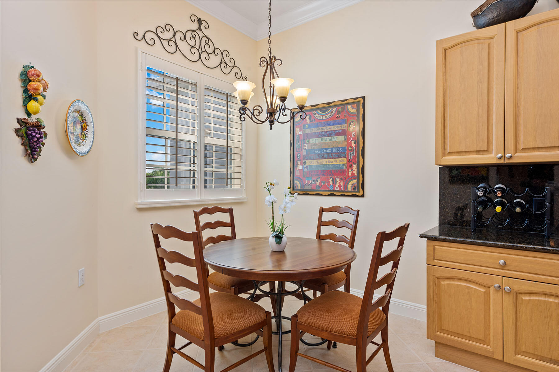 9259 Museo Circle, Unit 203 Naples, FL 34114 - Photo 8 of 46 a view of a dining room with furniture a chandelier and wooden floor