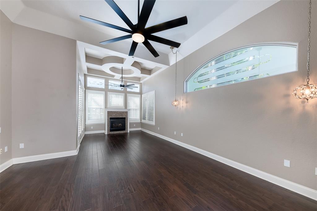 5331 Vista Club Run Sanford, FL 32771 - Photo 20 of 53 an empty room with wooden floor chandelier fan and windows