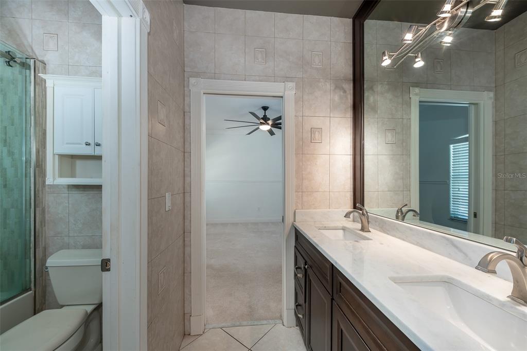 5331 Vista Club Run Sanford, FL 32771 - Photo 29 of 53 a bathroom with a double vanity sink toilet and shower