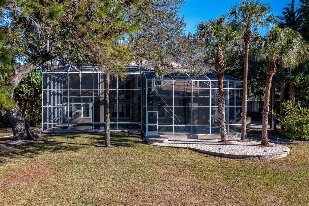 5331 Vista Club Run Sanford, FL 32771 - Photo 48 of 53 a view of a swimming pool with potted plants and large trees