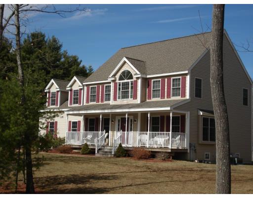 39 Shaker Road Shirley, MA 01464 - Photo 1 of 15 a front view of a house with a yard