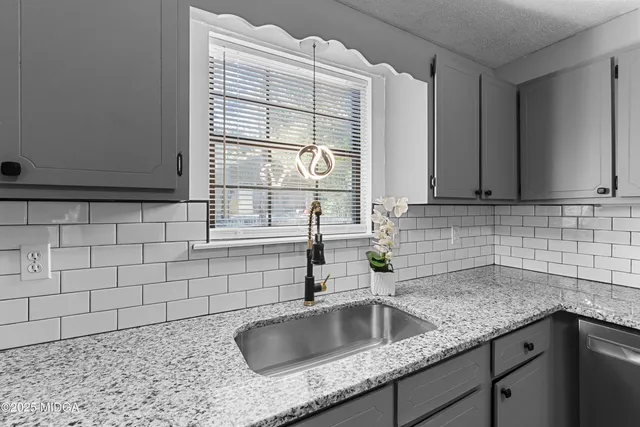 a kitchen with a sink and cabinets
