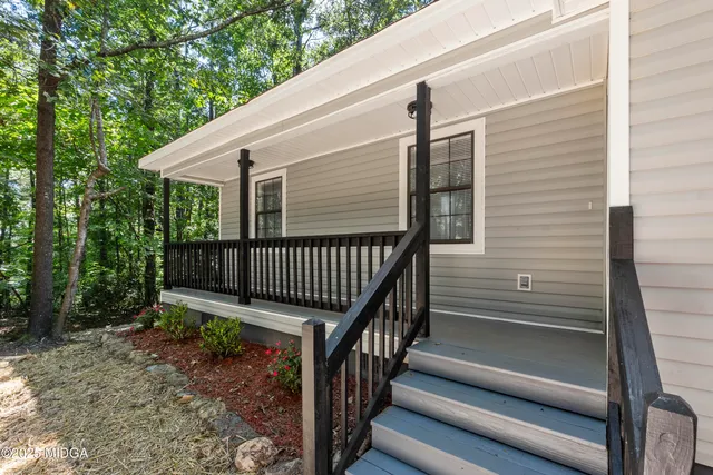 a view of backyard with deck and wooden floor