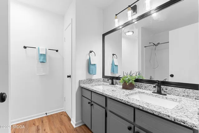 a bathroom with a granite countertop sink and a mirror