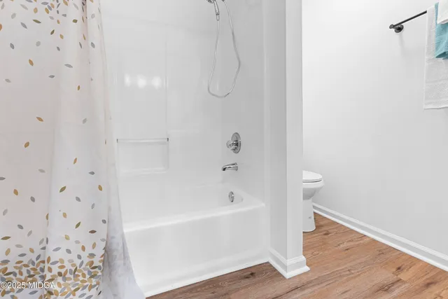a bathroom with a bathtub and shower