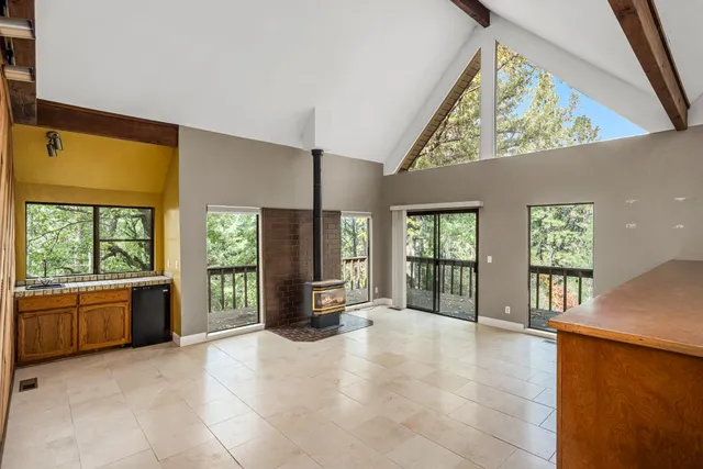 a view of an empty room with a fireplace and a window
