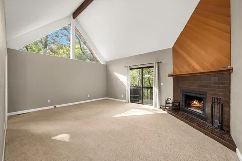 a view of a hallway with entryway wooden floor and cabinet