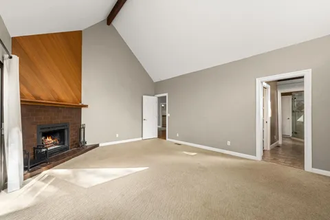 a view of a big room with wooden floor and a ceiling fan