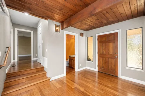 a kitchen with stainless steel appliances granite countertop a refrigerator and a stove top oven