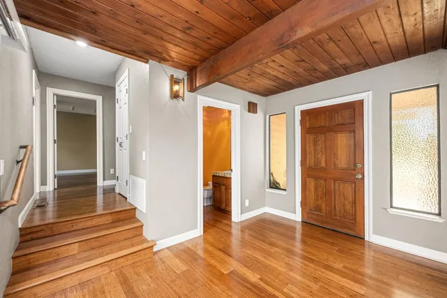 a kitchen with stainless steel appliances granite countertop a refrigerator and a stove top oven