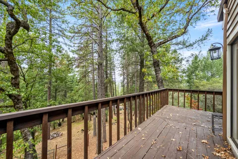 an aerial view of a house a yard and a lake view