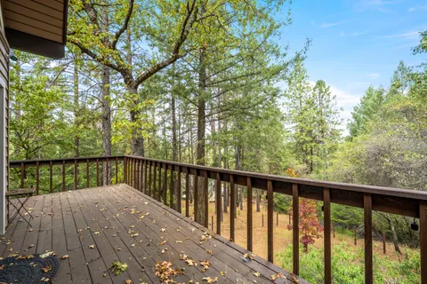 a view of a house with a backyard and trees