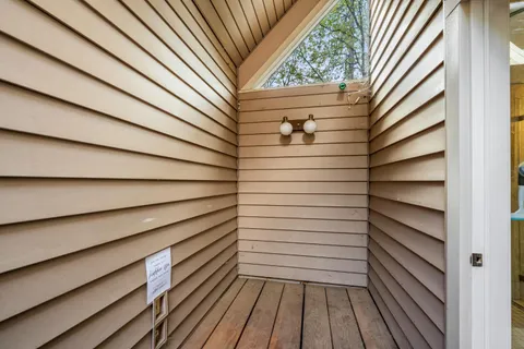 an aerial view of a house with pool and garden