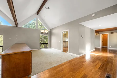 a kitchen with granite countertop a stove a sink and a refrigerator