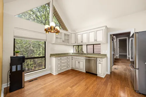 a view of empty room with wooden floor