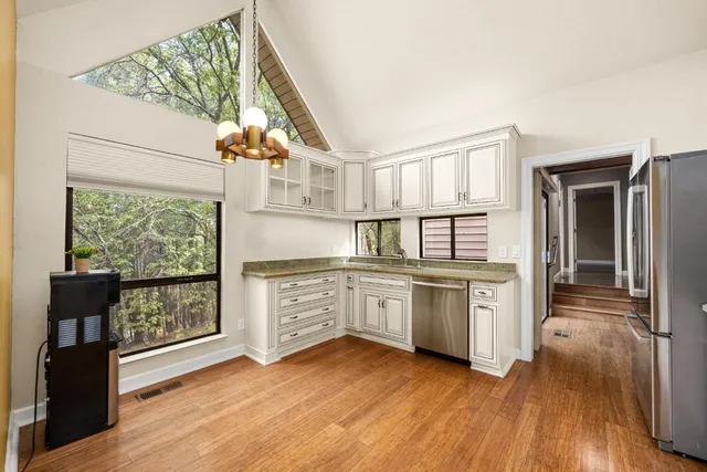 a view of empty room with wooden floor