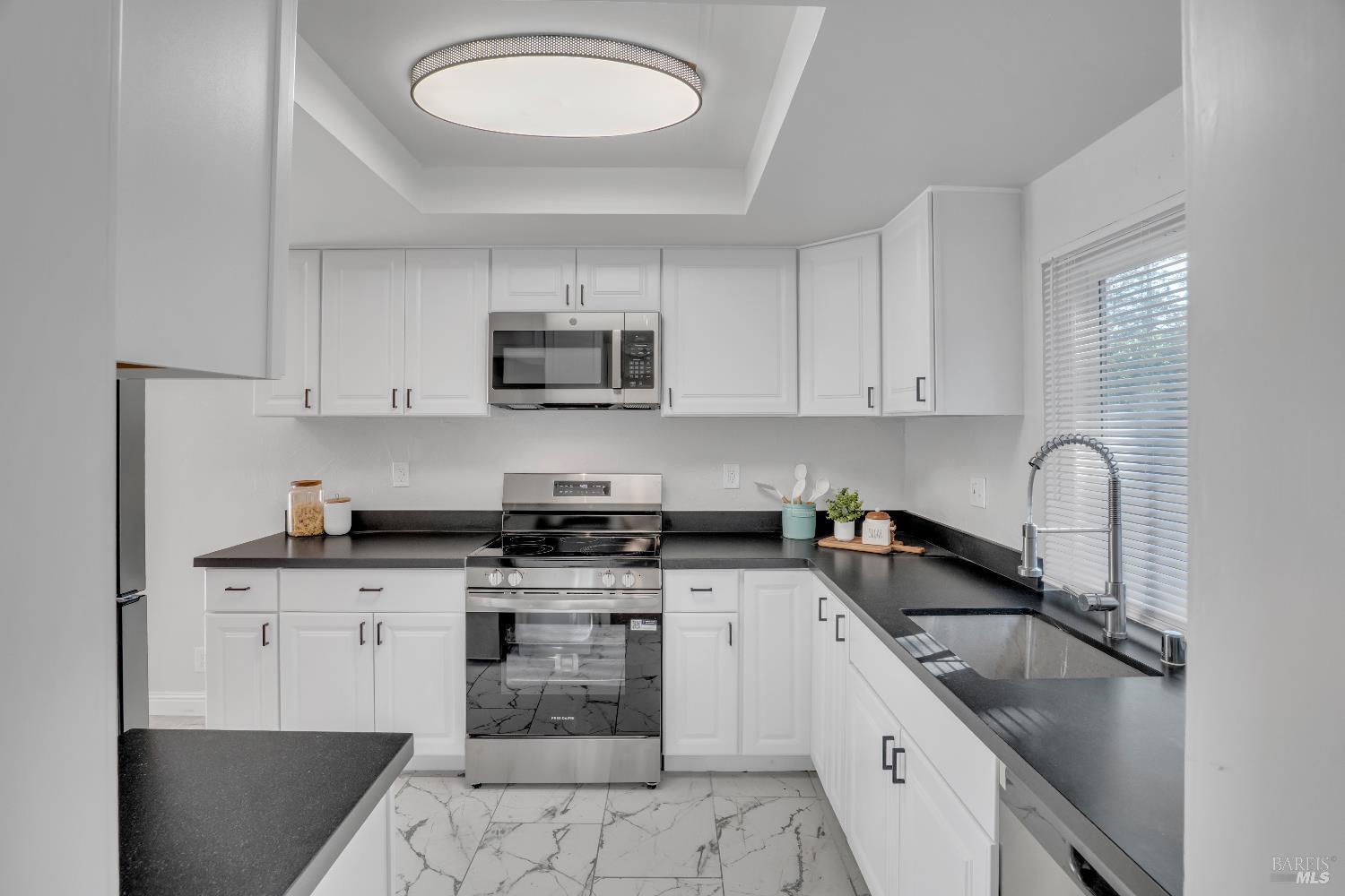 2785 Canyon Creek Drive San Ramon, CA 94583 - Photo 10 of 36 a kitchen with stainless steel appliances granite countertop a sink a stove top oven a counter space and cabinets