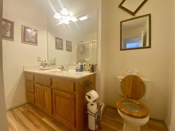 a kitchen with granite countertop a sink cabinets and wooden floor