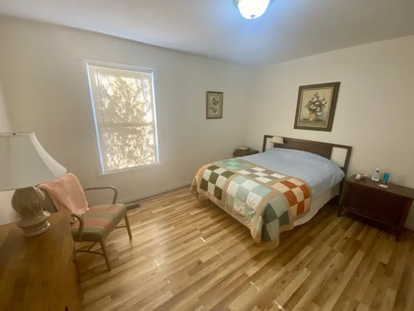 a bedroom with a bed and window