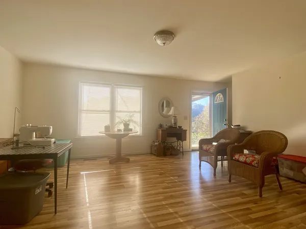 a living room with furniture window and wooden floor
