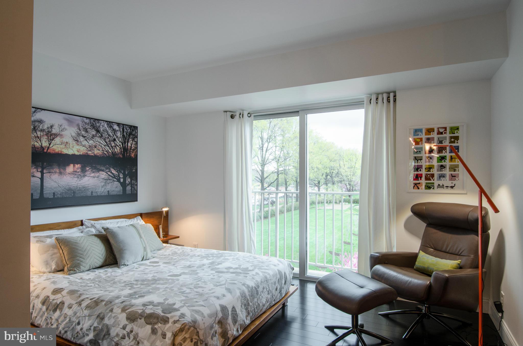 550 N Street Southwest, Unit S201 Washington, DC 20024 - Photo 19 of 30 a bedroom with a bed and a chair