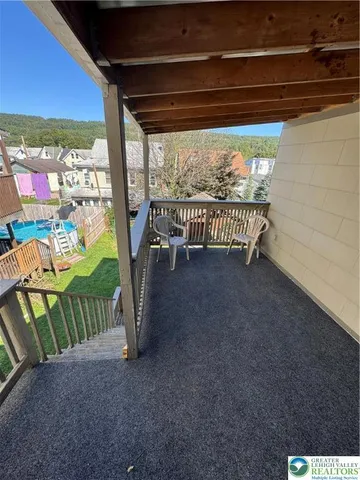 a view of a wooden deck and a yard