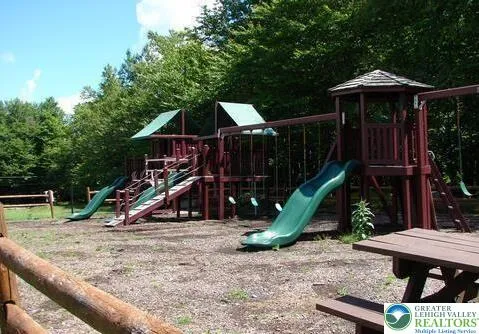 a view of a wooden deck with chairs and a slide