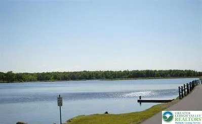 a view of a lake with houses in the background