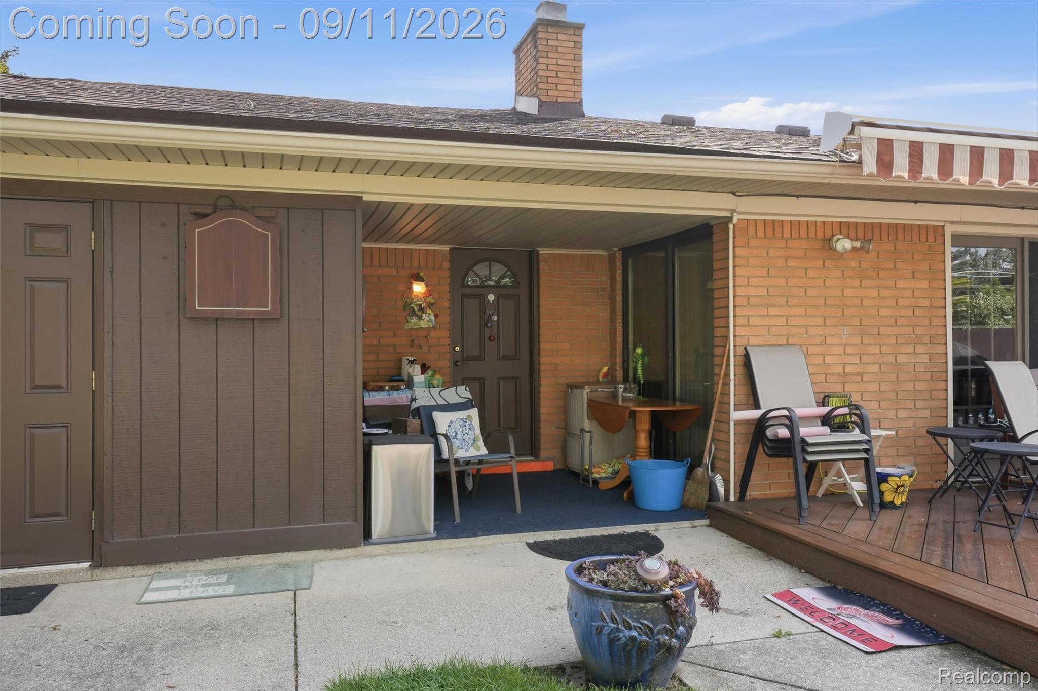 16799 Farmington Road Livonia, MI 48154 - Photo 53 of 71 Brick exterior with a covered patio area, concrete patio, and an elevated wood deck