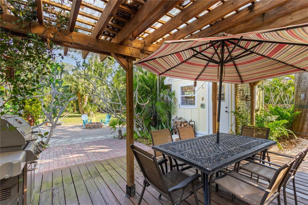 109 Burney Road Osprey, FL 34229 - Photo 36 of 56 Covered 16 ft. x 20 ft. back deck with step down to huge back yard.