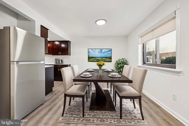 a view of empty room with wooden floor and fireplace