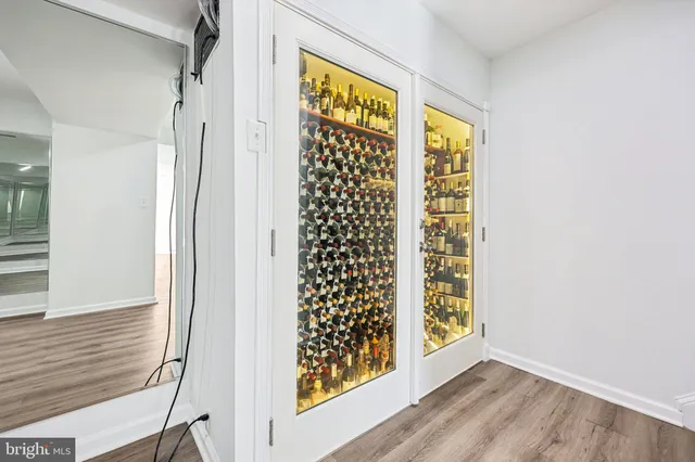 a view of backyard with wooden fence and large trees