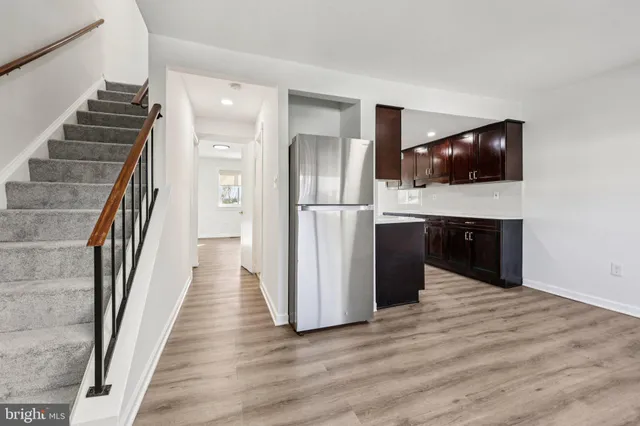 a kitchen with stainless steel appliances granite countertop a stove and a wooden floors
