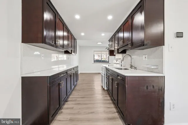 a view of a livingroom with wooden floor and a fireplace