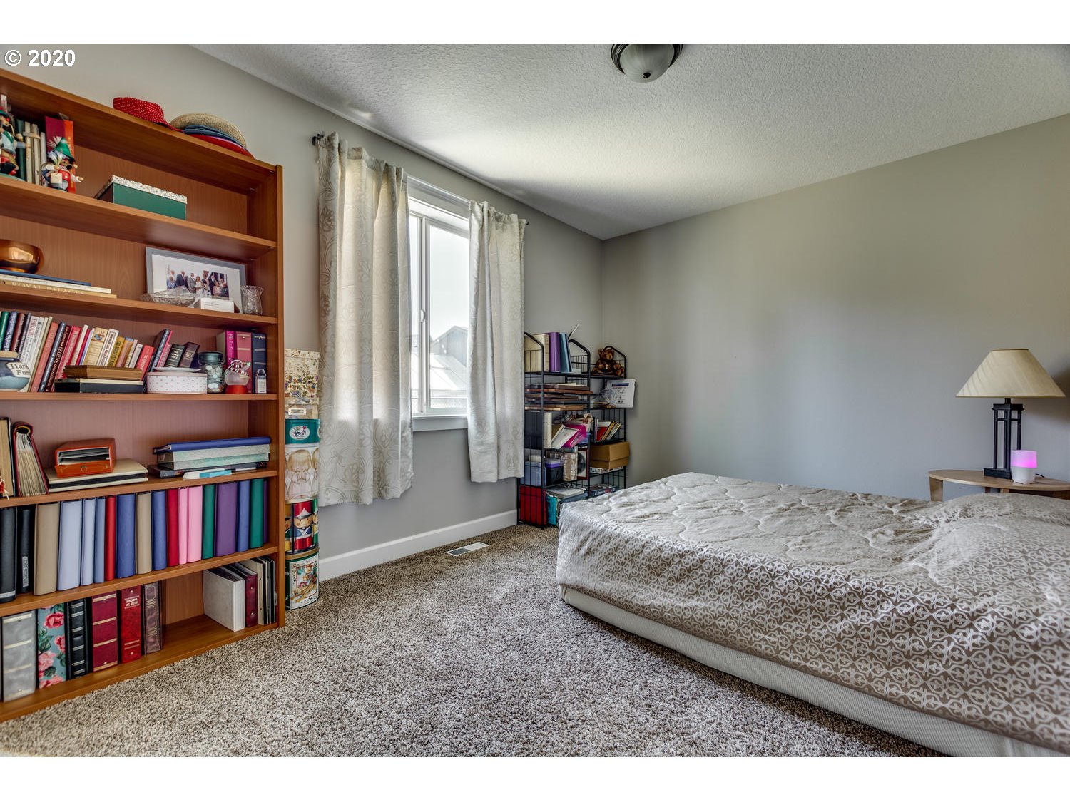 1704 Northwest 179th Street Ridgefield, WA 98642 - Photo 18 of 28 a bedroom with a bed a book shelf and a window