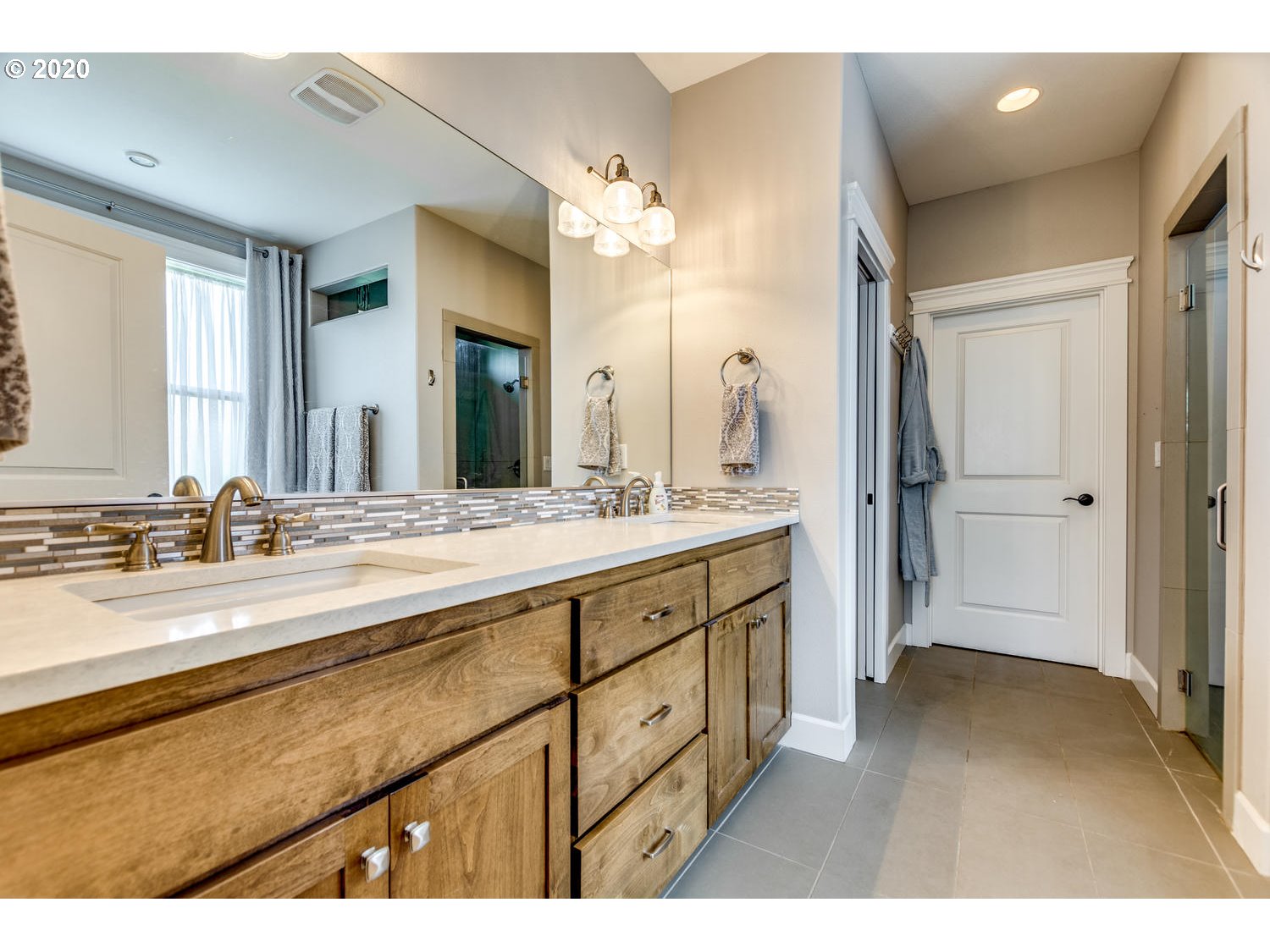 1704 Northwest 179th Street Ridgefield, WA 98642 - Photo 20 of 28 a spacious bathroom with a double vanity sink and mirror