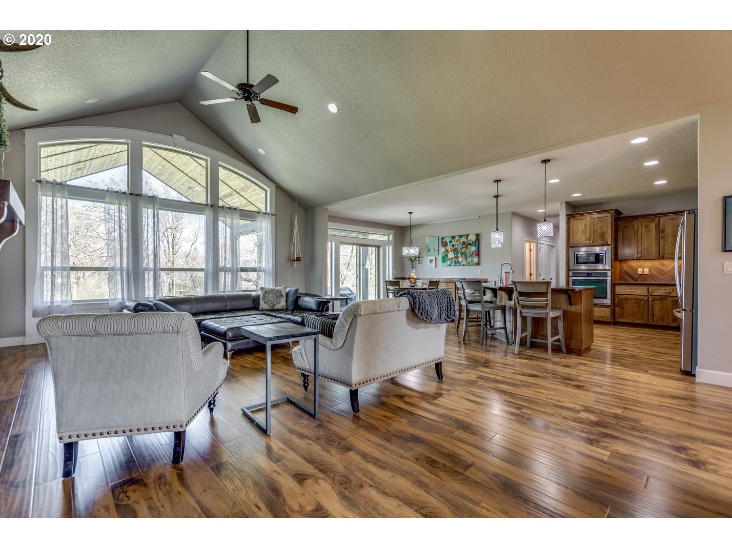 1704 Northwest 179th Street Ridgefield, WA 98642 - Photo 7 of 28 a living room with furniture a wooden floor and a large window