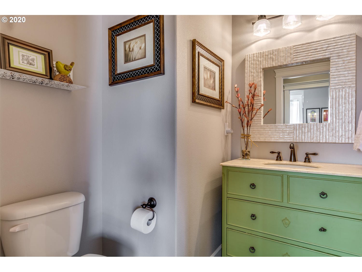 1704 Northwest 179th Street Ridgefield, WA 98642 - Photo 9 of 28 a bathroom with a toilet sink a mirror and vanity