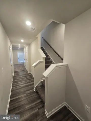 a view of entryway and hall with wooden floor