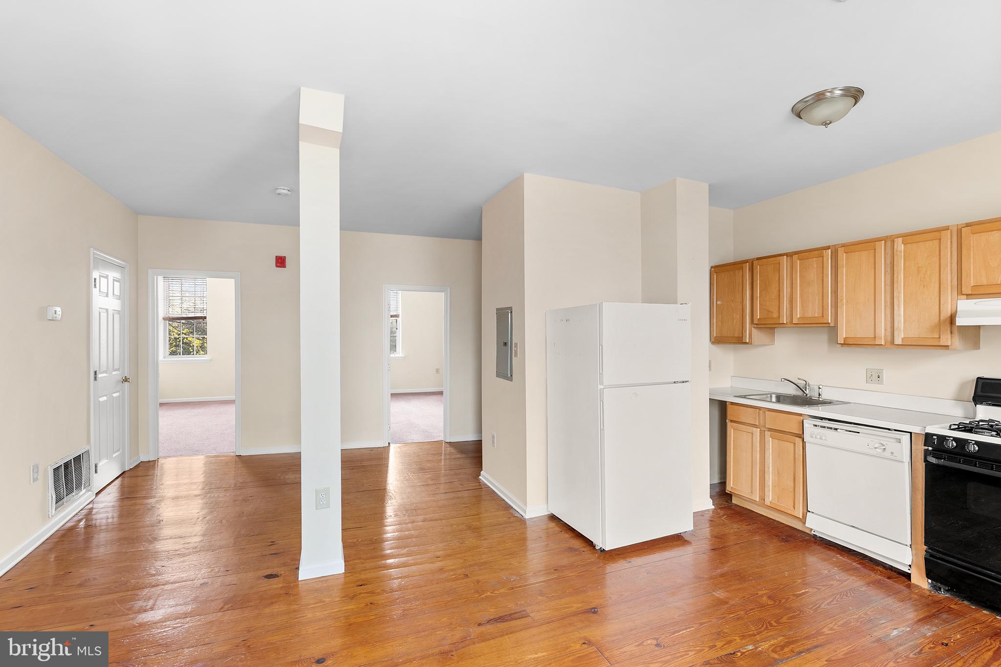 a kitchen with a refrigerator and a stove top oven