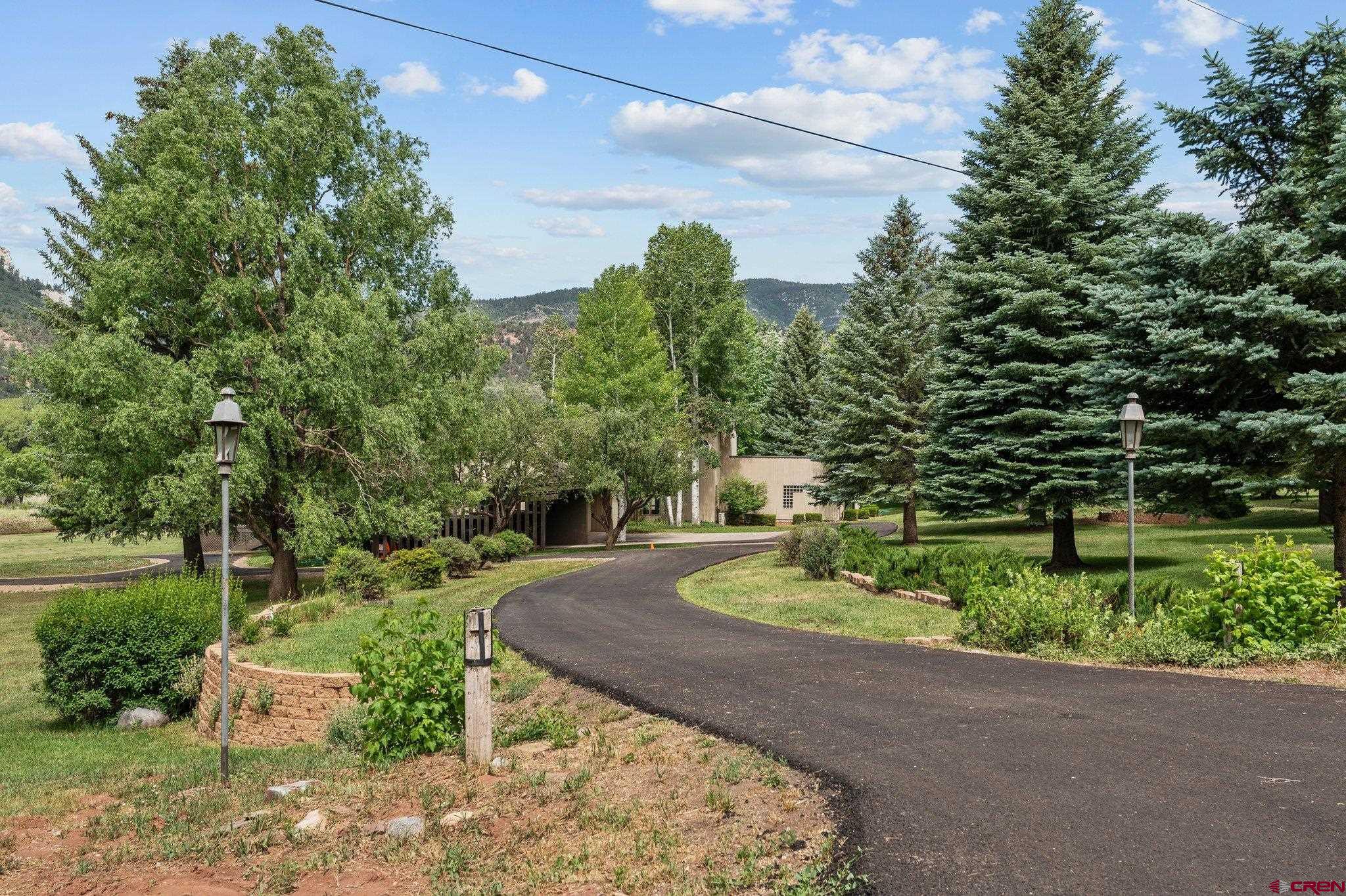 2565 County Road 250 Durango, CO 81301 - Photo 11 of 35 a backyard of a house with a yard and outdoor seating