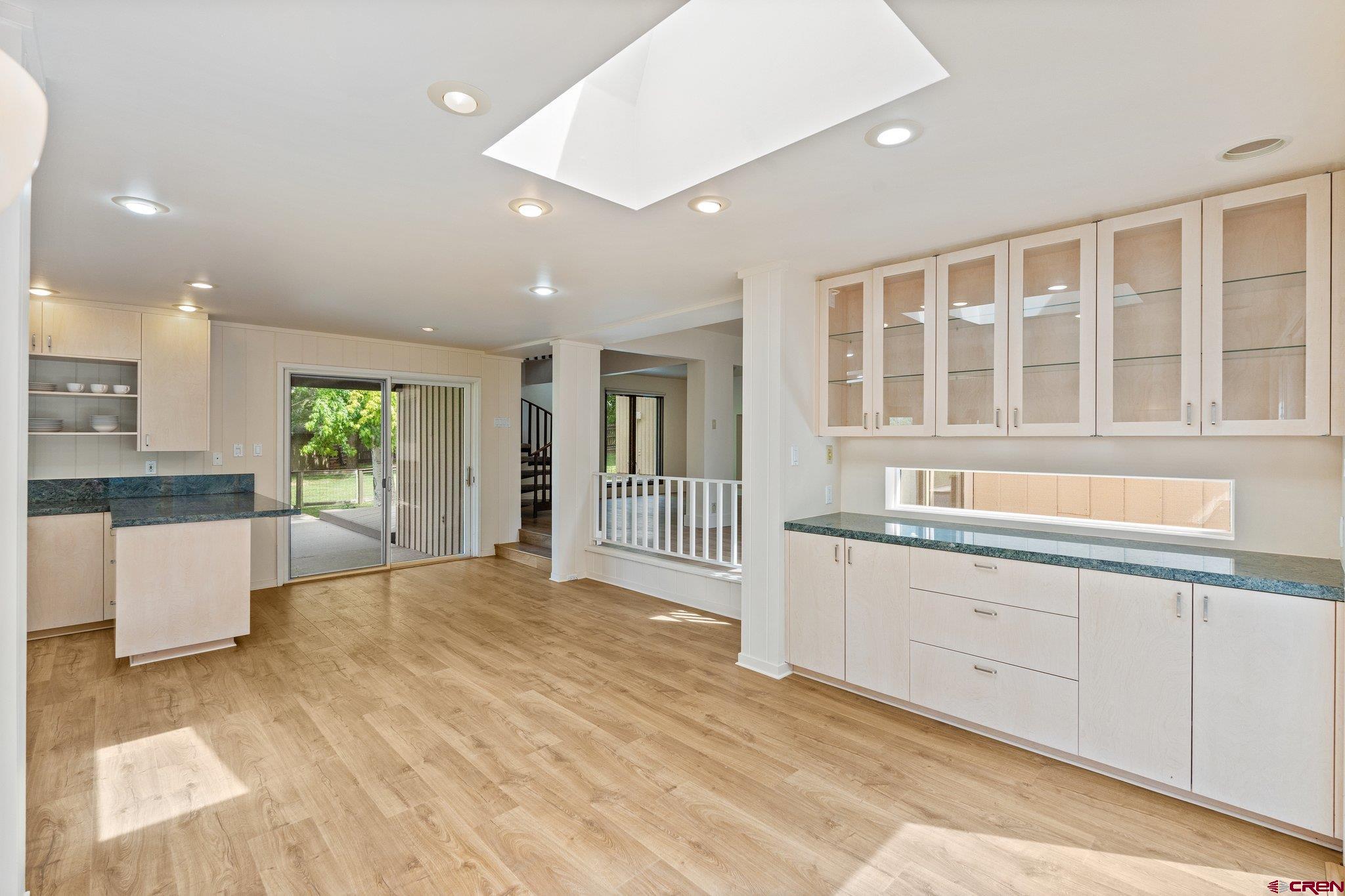 2565 County Road 250 Durango, CO 81301 - Photo 18 of 35 a large white kitchen with kitchen island a sink wooden floor and a large window