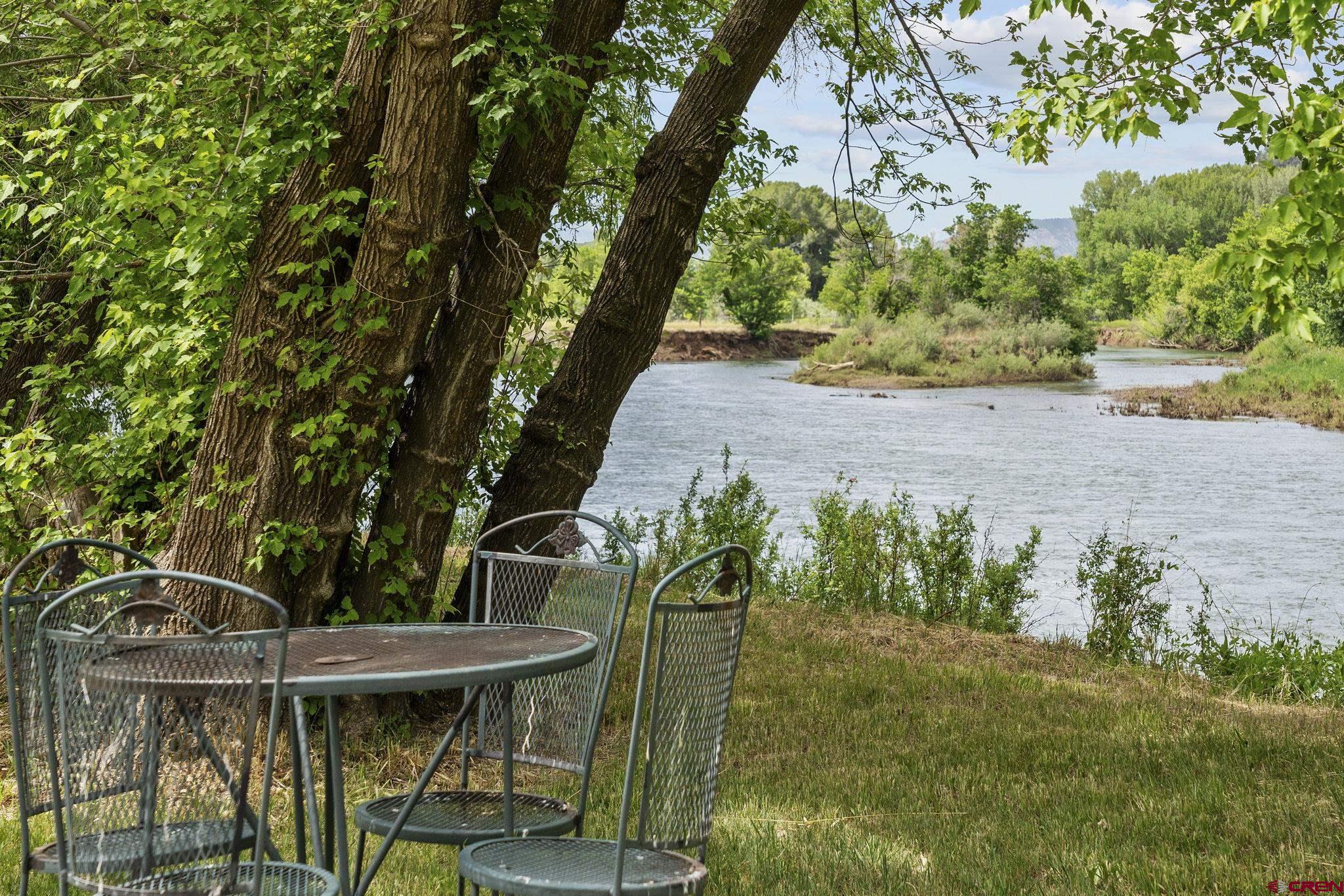 2565 County Road 250 Durango, CO 81301 - Photo 2 of 35 a backyard of a house with table and chairs