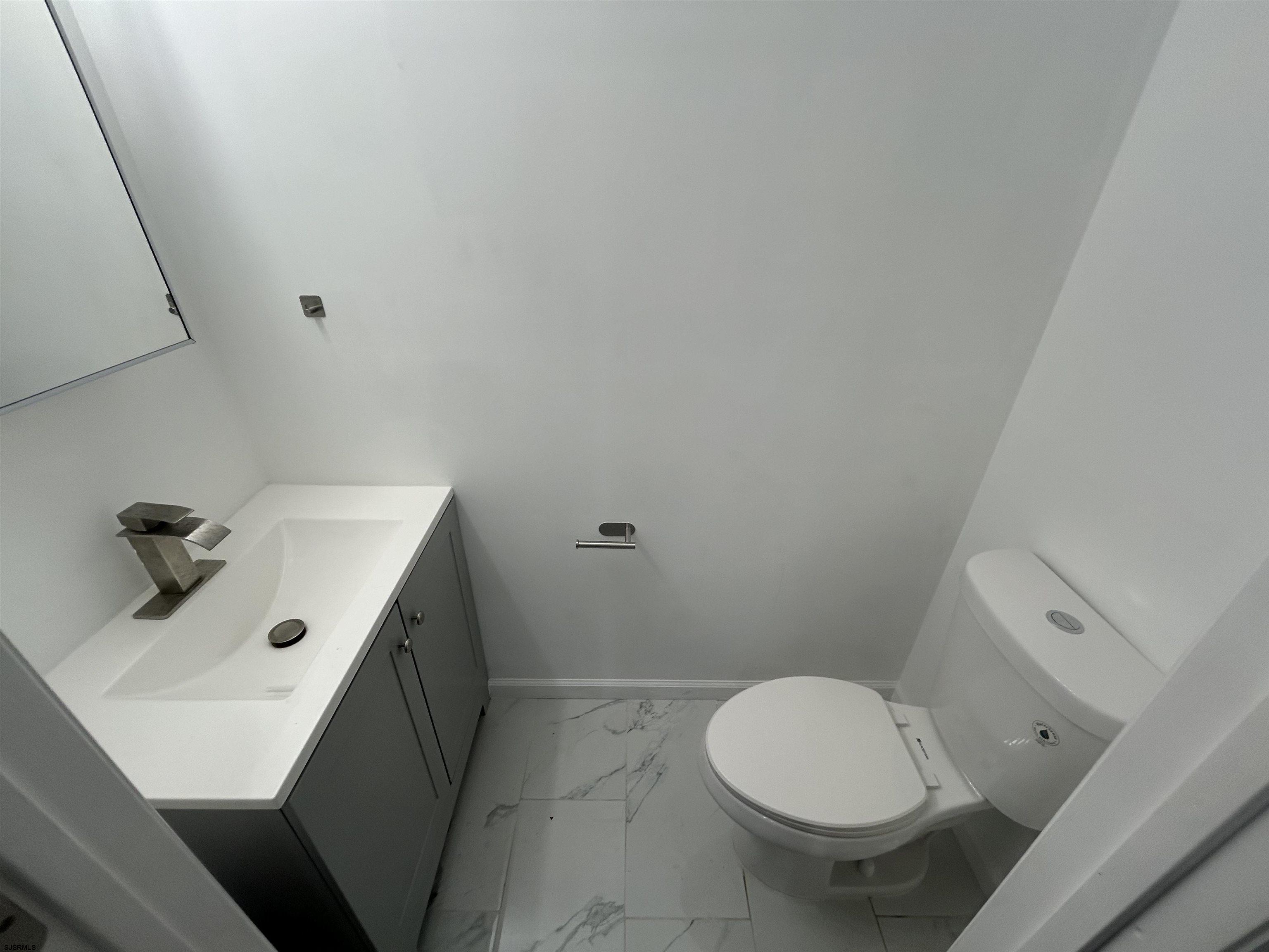 2821 Arctic Avenue, Unit 1 Atlantic City, NJ 08401 - Photo 10 of 10 a bathroom with a sink toilet and mirror