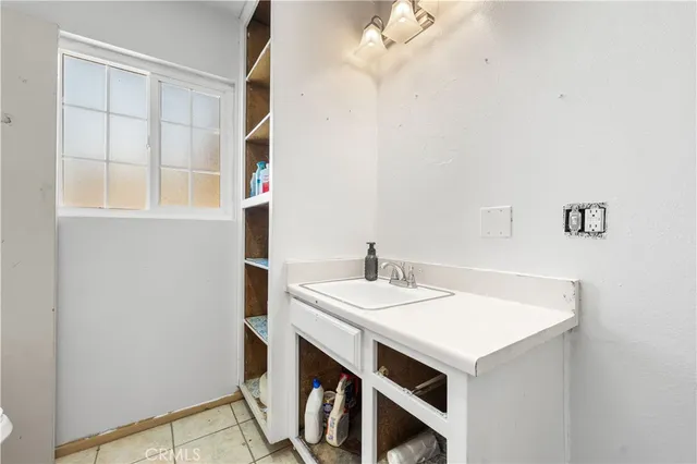 a view of storage and utility room with cabinet