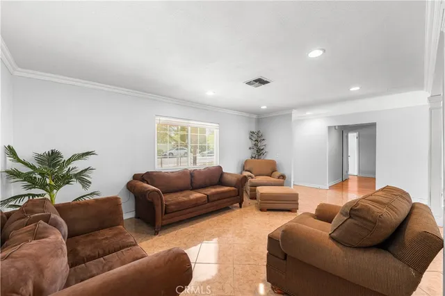 a living room with furniture a couch and a potted plant