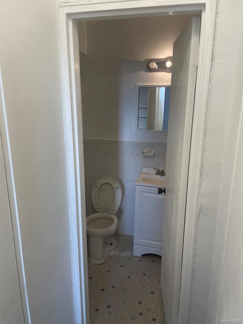 151-05 Cross Island Parkway, Unit 2F Queens, NY 11357 - Photo 15 of 16 a bathroom with a toilet and a sink