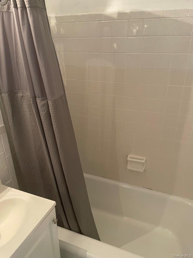 151-05 Cross Island Parkway, Unit 2F Queens, NY 11357 - Photo 16 of 16 a bathroom with bathtub