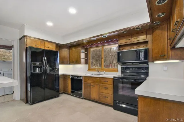 a kitchen with cabinets and stainless steel appliances