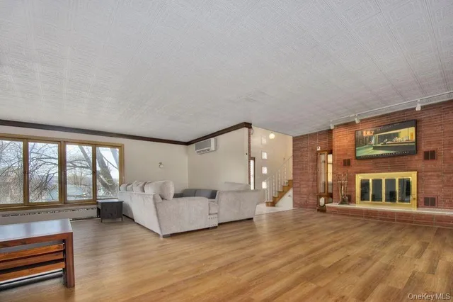 a living room with furniture and large windows